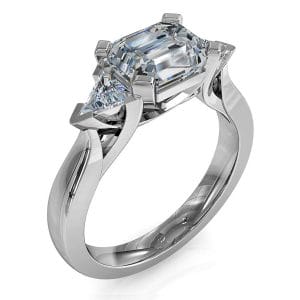 Emerald Cut Trilogy Diamond Engagement Ring, Horizontal Set with Trilliant Side Stones and a Sweeping Undersetting.